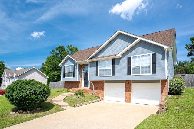 6220 Hunter Valley Rd, Ooltewah, TN 37363 - raised ranch featuring concrete driveway, an attached garage, brick siding, and roof with shingles