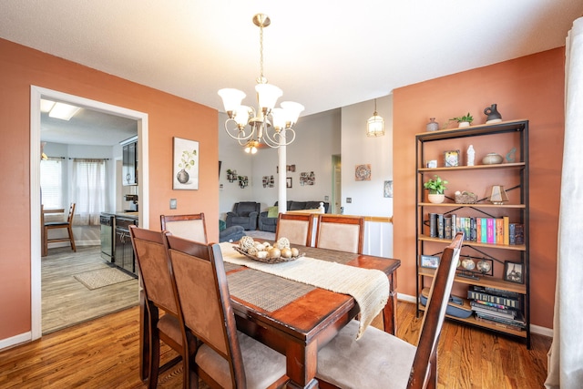 6220 Hunter Valley Rd, Ooltewah, TN 37363 - dining space featuring a chandelier and wood finished floors