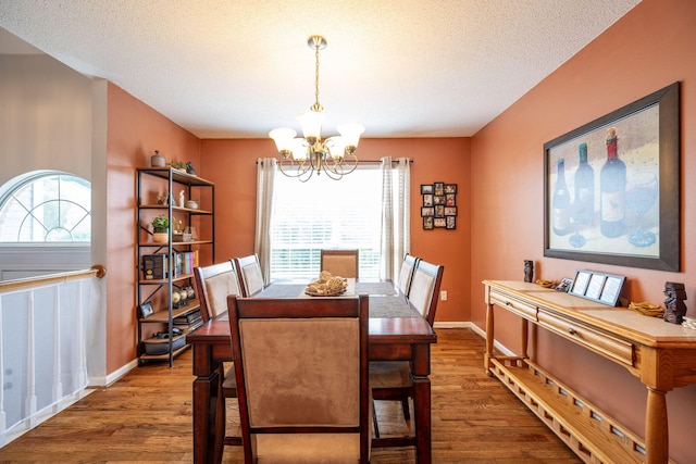 6220 Hunter Valley Rd, Ooltewah, TN 37363 - dining room with a chandelier, wood finished floors, healthy amount of natural light, and a textured ceiling