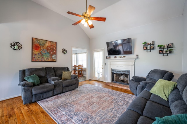 6220 Hunter Valley Rd, Ooltewah, TN 37363 - living area featuring high vaulted ceiling, ceiling fan, wood finished floors, and a fireplace with raised hearth