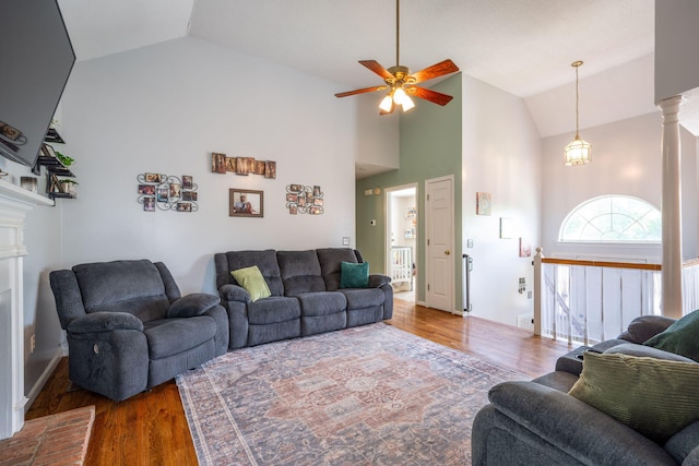 6220 Hunter Valley Rd, Ooltewah, TN 37363 - living room featuring wood finished floors, a ceiling fan, high vaulted ceiling, and a fireplace with raised hearth