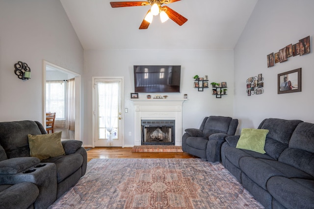 6220 Hunter Valley Rd, Ooltewah, TN 37363 - living area featuring a ceiling fan, wood finished floors, a fireplace with raised hearth, and high vaulted ceiling