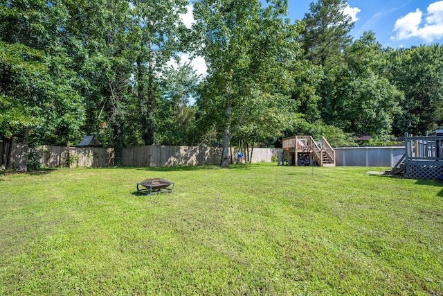 6220 Hunter Valley Rd, Ooltewah, TN 37363 - fenced backyard featuring an outdoor fire pit, a deck, and stairway