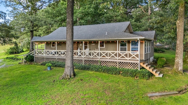 684 Mcconnell Xing, Lafayette, GA 30728 - view of front of home with covered porch, a front lawn, a shingled roof, and view of wooded area