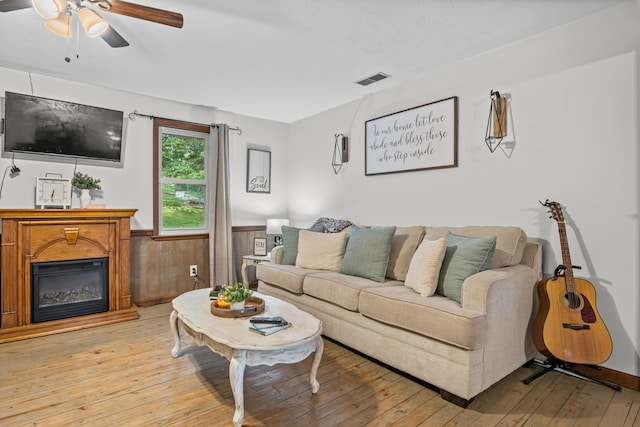 684 Mcconnell Xing, Lafayette, GA 30728 - living room with ceiling fan, light wood-style flooring, a wainscoted wall, and a glass covered fireplace