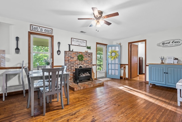 684 Mcconnell Xing, Lafayette, GA 30728 - dining room featuring a wood stove, a ceiling fan, and hardwood / wood-style floors