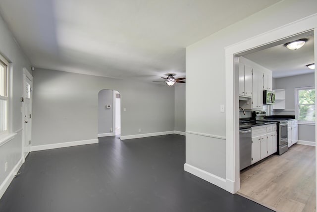 1728 John Ross Rd, Chattanooga, TN 37412 - kitchen with appliances with stainless steel finishes, a ceiling fan, arched walkways, and white cabinetry