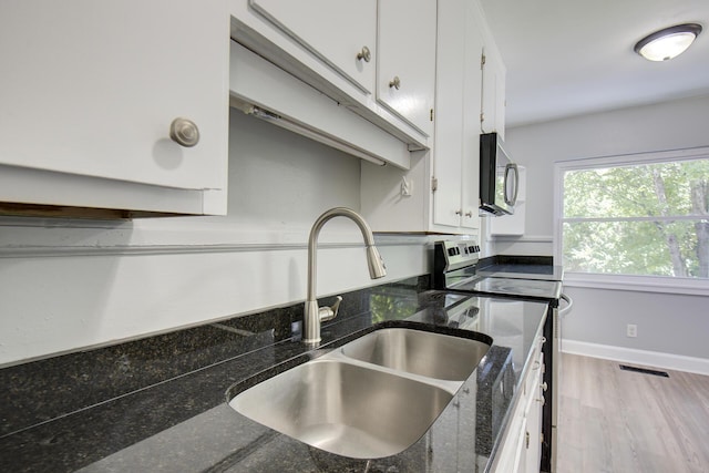 1728 John Ross Rd, Chattanooga, TN 37412 - kitchen with appliances with stainless steel finishes, white cabinetry, dark stone counters, and wood finished floors