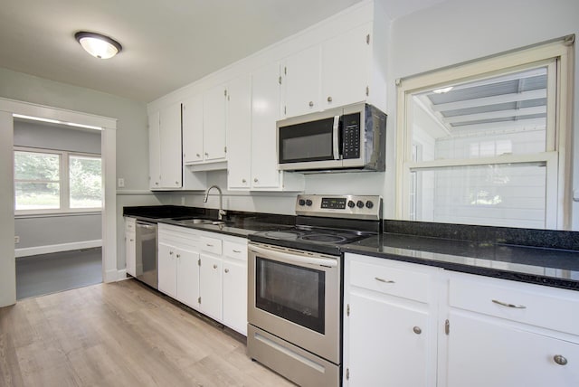 1728 John Ross Rd, Chattanooga, TN 37412 - kitchen with stainless steel appliances, light wood finished floors, white cabinetry, and dark stone countertops