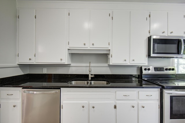 1728 John Ross Rd, Chattanooga, TN 37412 - kitchen with stainless steel appliances, white cabinets, and dark stone counters