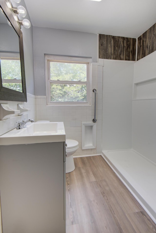 1728 John Ross Rd, Chattanooga, TN 37412 - bathroom with tile walls, vanity, a shower, wainscoting, and wood finished floors