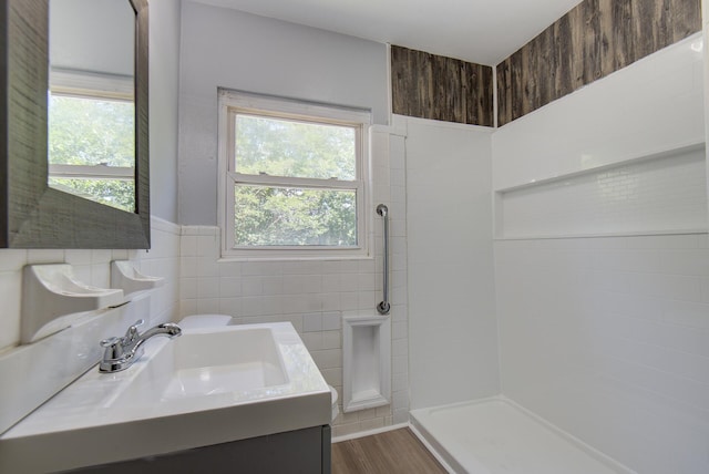 1728 John Ross Rd, Chattanooga, TN 37412 - full bath with healthy amount of natural light, tile walls, vanity, a tile shower, and wood finished floors