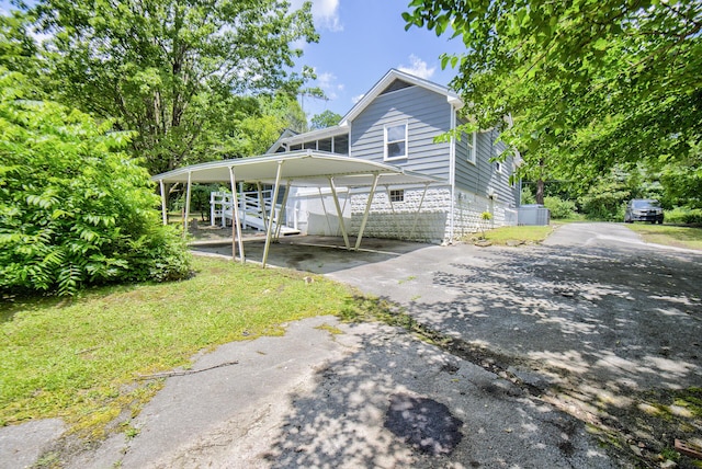 1728 John Ross Rd, Chattanooga, TN 37412 - view of front of house with asphalt driveway, a carport, and a front yard