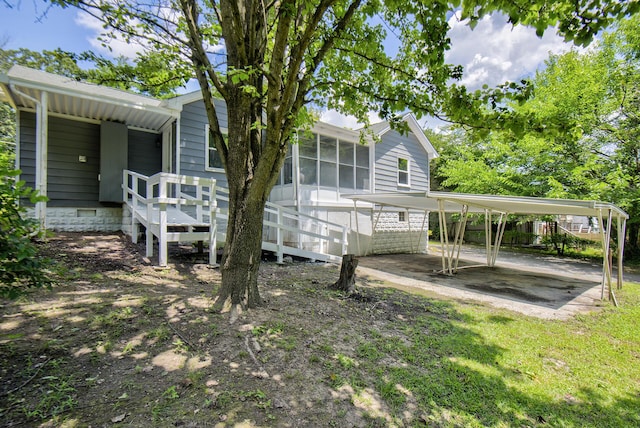 1728 John Ross Rd, Chattanooga, TN 37412 - back of property featuring a detached carport, a sunroom, and crawl space