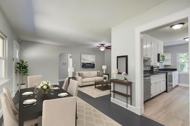 1728 John Ross Rd, Chattanooga, TN 37412 - dining area with arched walkways, light wood-style floors, and ceiling fan