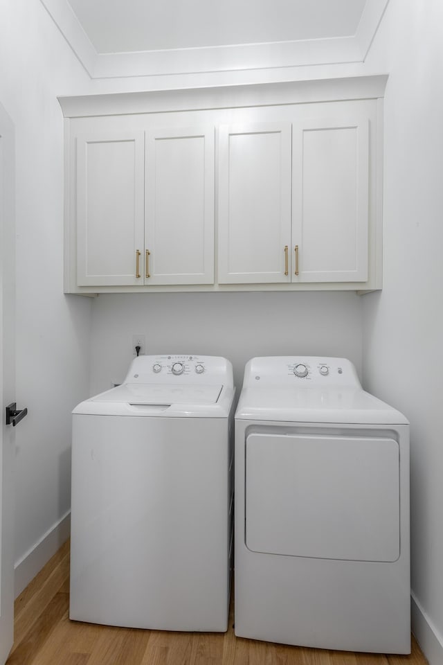 3117 Greenwich Ave, Chattanooga, TN 37415 - washroom with separate washer and dryer, cabinet space, and wood finished floors