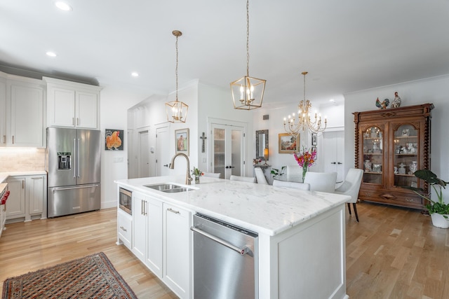 3117 Greenwich Ave, Chattanooga, TN 37415 - kitchen with appliances with stainless steel finishes, a chandelier, french doors, light wood-style flooring, and white cabinets