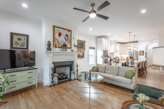 3117 Greenwich Ave, Chattanooga, TN 37415 - living room with crown molding, a ceiling fan, light wood-style flooring, a fireplace with flush hearth, and recessed lighting