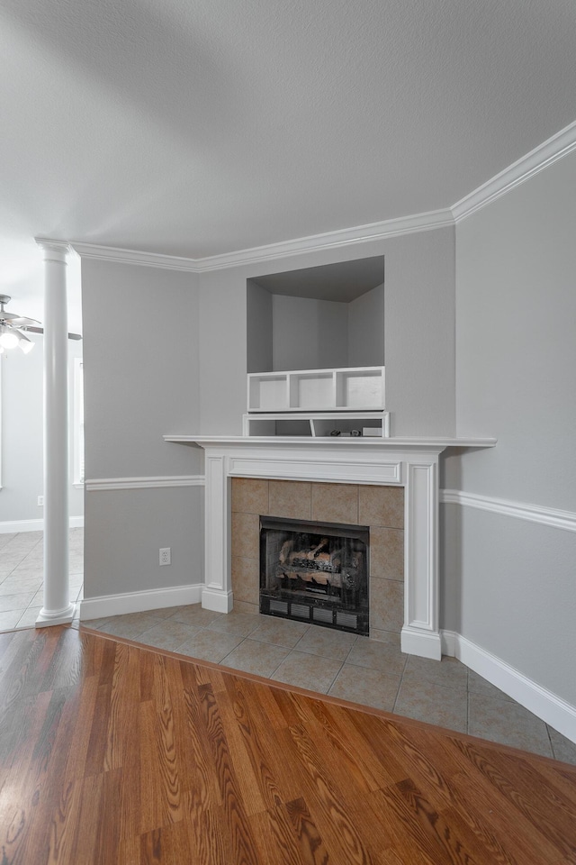 802 Applebrook Dr Unit 802, Rossville, GA 30741 - unfurnished living room featuring decorative columns, a tiled fireplace, ornamental molding, wood finished floors, and ceiling fan