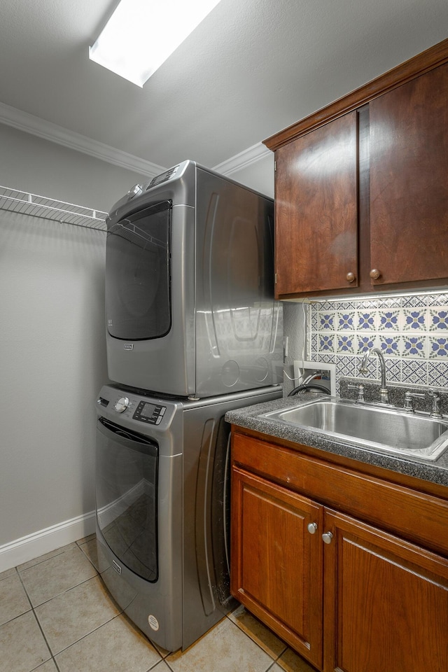 802 Applebrook Dr Unit 802, Rossville, GA 30741 - laundry room with estacked washer and dryer, cabinet space, crown molding, and light tile patterned floors