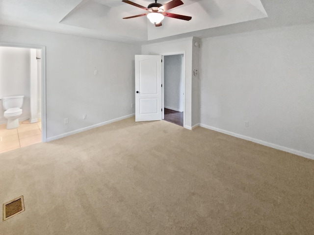 7110 Ridgestone Dr, Ooltewah, TN 37363 - unfurnished bedroom with carpet flooring, ensuite bath, a ceiling fan, and a raised ceiling