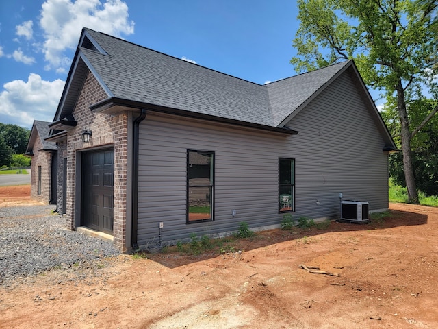 202 Cheshire Crossing Dr, Rock Spring, GA 30739 - view of property exterior with roof with shingles, gravel driveway, and a garage