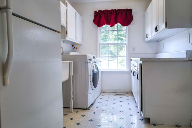 732 Salem Rd, Rossville, GA 30741 - laundry area with cabinet space, washer and clothes dryer, and healthy amount of natural light