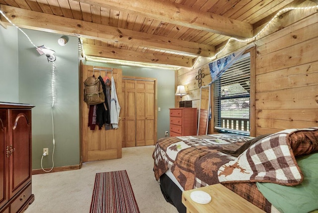 2875 Stagecoach Rd, Sewanee, TN 37375 - bedroom with a wooden ceiling with exposed beams, light colored carpet, wooden walls, and a closet