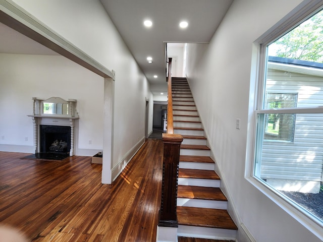 1 Magnolia St, Niota, TN 37826 - stairs featuring hardwood / wood-style flooring, a fireplace with flush hearth, and recessed lighting