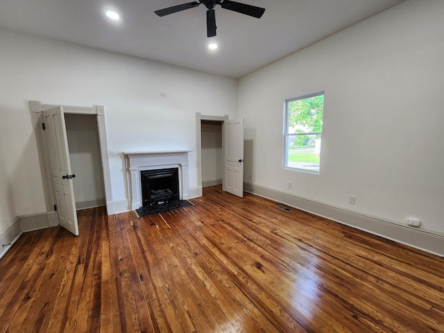 1 Magnolia St, Niota, TN 37826 - unfurnished living room with wood-type flooring, a fireplace with flush hearth, and a ceiling fan