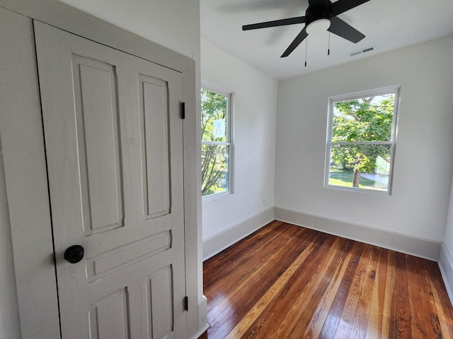 1 Magnolia St, Niota, TN 37826 - unfurnished bedroom with multiple windows, wood-type flooring, and ceiling fan