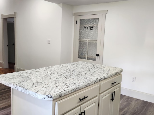1 Magnolia St, Niota, TN 37826 - kitchen with dark wood finished floors, a kitchen island, and white cabinetry