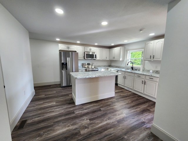 1 Magnolia St, Niota, TN 37826 - kitchen featuring appliances with stainless steel finishes, dark wood-style flooring, white cabinets, light stone counters, and recessed lighting