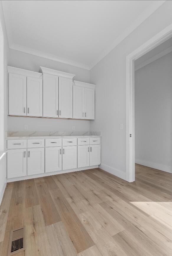 10541 E Brainerd Rd, Apison, TN 37302 - kitchen featuring white cabinets, light wood-style flooring, light countertops, and ornamental molding