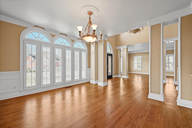 6401 Beacon Pointe Cir, Hixson, TN 37343 - unfurnished dining area featuring a chandelier, ornate columns, wood finished floors, and crown molding