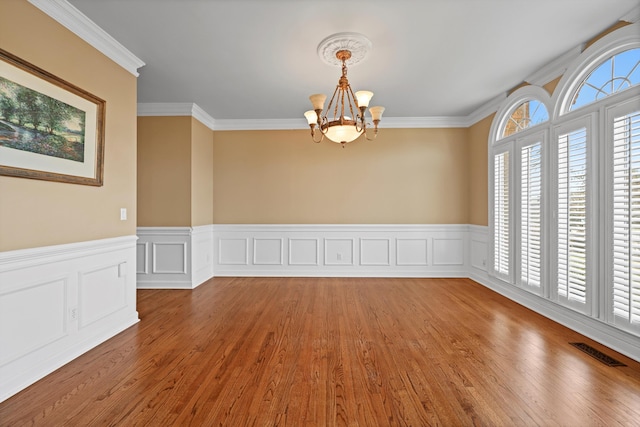 6401 Beacon Pointe Cir, Hixson, TN 37343 - empty room featuring a chandelier, a wainscoted wall, wood finished floors, and crown molding