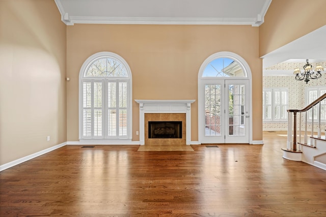 6401 Beacon Pointe Cir, Hixson, TN 37343 - unfurnished living room with a tile fireplace, wood finished floors, plenty of natural light, and ornamental molding