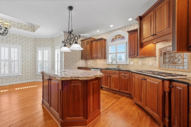 6401 Beacon Pointe Cir, Hixson, TN 37343 - kitchen featuring light wood finished floors, a center island, light stone counters, a chandelier, and decorative backsplash