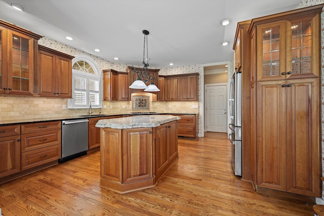 6401 Beacon Pointe Cir, Hixson, TN 37343 - kitchen featuring stainless steel appliances, a kitchen island, brown cabinets, light wood-style flooring, and recessed lighting