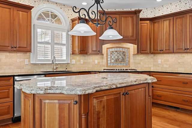 6401 Beacon Pointe Cir, Hixson, TN 37343 - kitchen featuring a center island, appliances with stainless steel finishes, light stone countertops, and brown cabinets