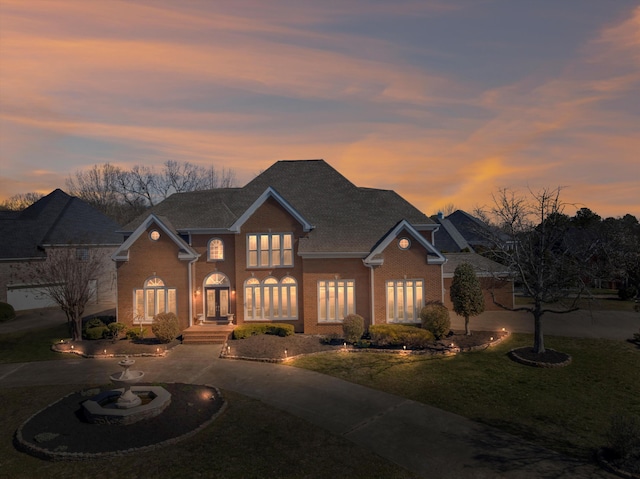 6401 Beacon Pointe Cir, Hixson, TN 37343 - traditional-style house featuring brick siding, a front yard, curved driveway, and french doors