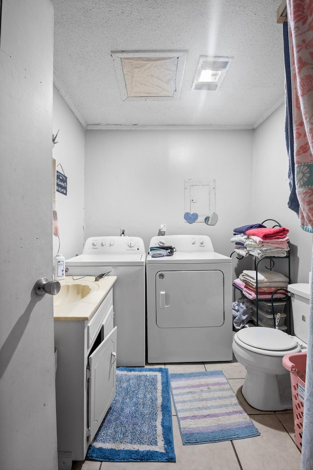 1618 E State Line Rd, Rossville, GA 30741 - laundry room featuring washer and dryer, light tile patterned floors, a textured ceiling, and attic access