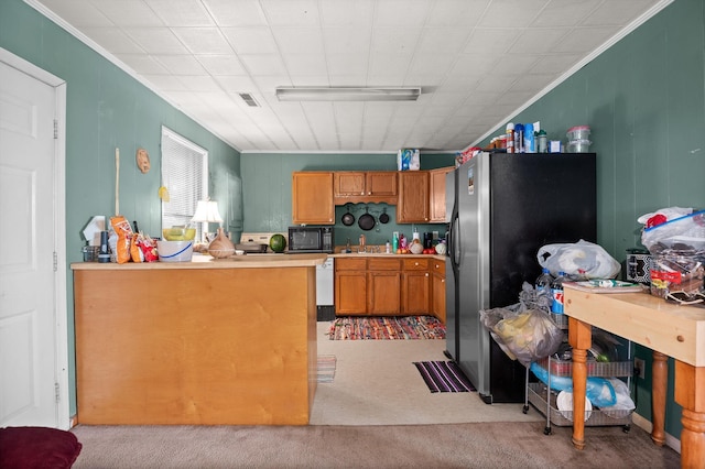 1618 E State Line Rd, Rossville, GA 30741 - kitchen with black microwave, carpet floors, ornamental molding, freestanding refrigerator, and light countertops