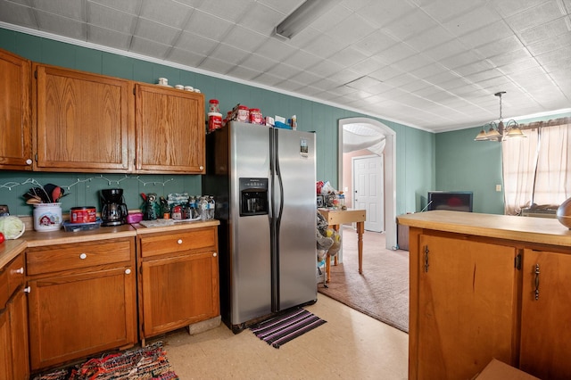 1618 E State Line Rd, Rossville, GA 30741 - kitchen with stainless steel refrigerator with ice dispenser, light flooring, light countertops, brown cabinetry, and ornamental molding