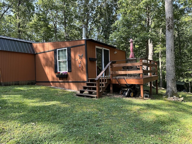 365 Green Dr Unit 4, Pikeville, TN 37367 - back of house featuring a wooden deck, a lawn, and view of wooded area