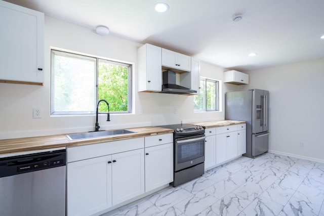 137 N Hidden Valley Rd, Rossville, GA 30741 - kitchen with butcher block countertops, appliances with stainless steel finishes, wall chimney range hood, white cabinetry, and recessed lighting
