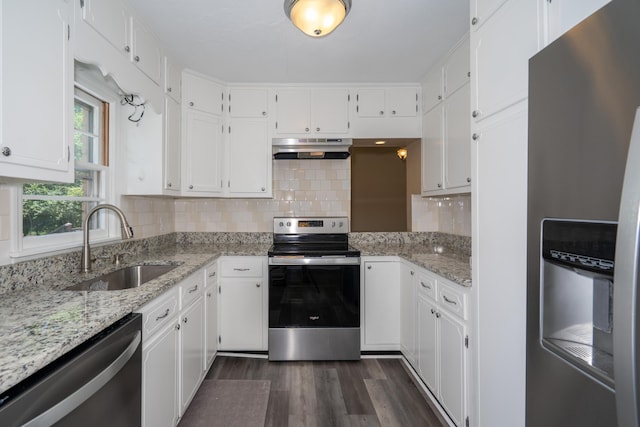 208 Wilder Rd, Chickamauga, GA 30707 - kitchen with appliances with stainless steel finishes, under cabinet range hood, white cabinetry, dark wood-style flooring, and tasteful backsplash