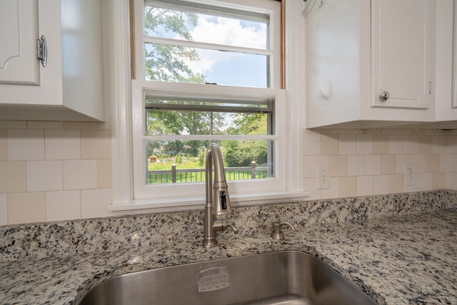 208 Wilder Rd, Chickamauga, GA 30707 - kitchen view of white cabinetry, tasteful backsplash, and light stone counters