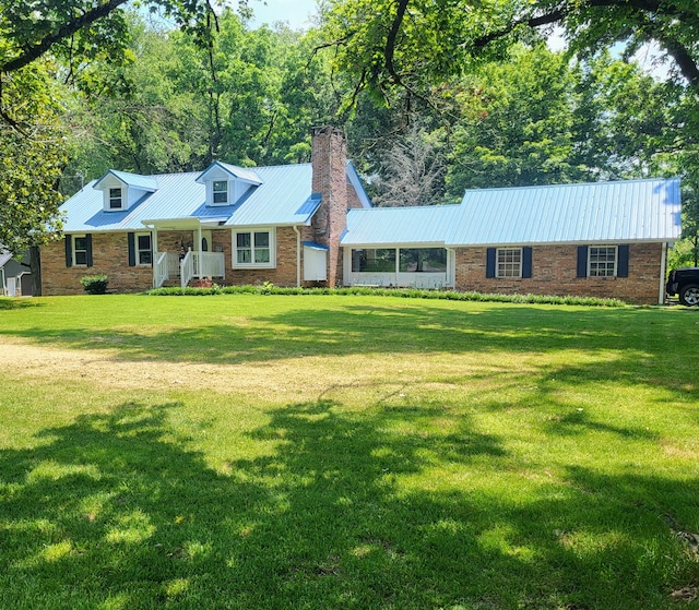 296 Davis Ln NW, Cleveland, TN 37312 - cape cod-style house featuring a chimney, a porch, a front lawn, and a metal roof