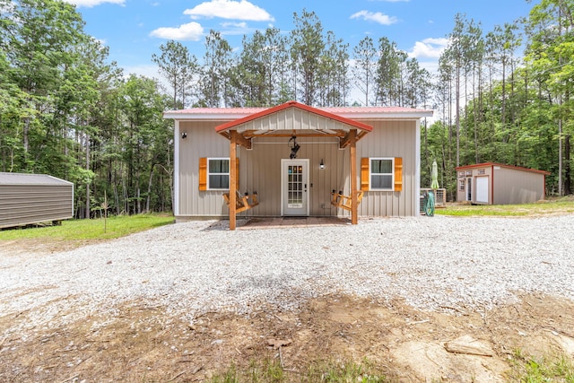 1780 Wolf Haven Rd, Spencer, TN 38585 - view of front facade with a storage unit and a metal roof